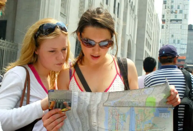 Two girls reading map