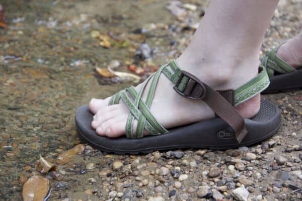 Hiking sandal next to stream