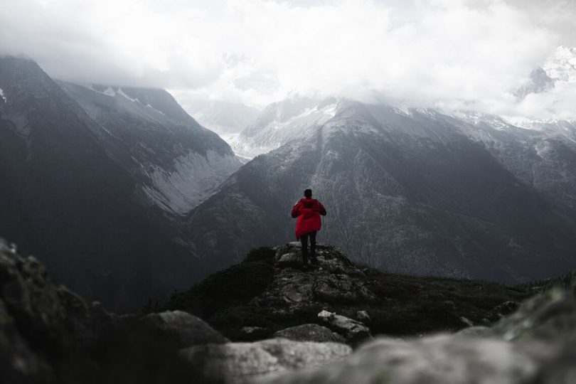 Hiker in Rainy Weather Admiring the View