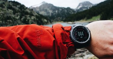 Hiker using GPS device on mountain trail