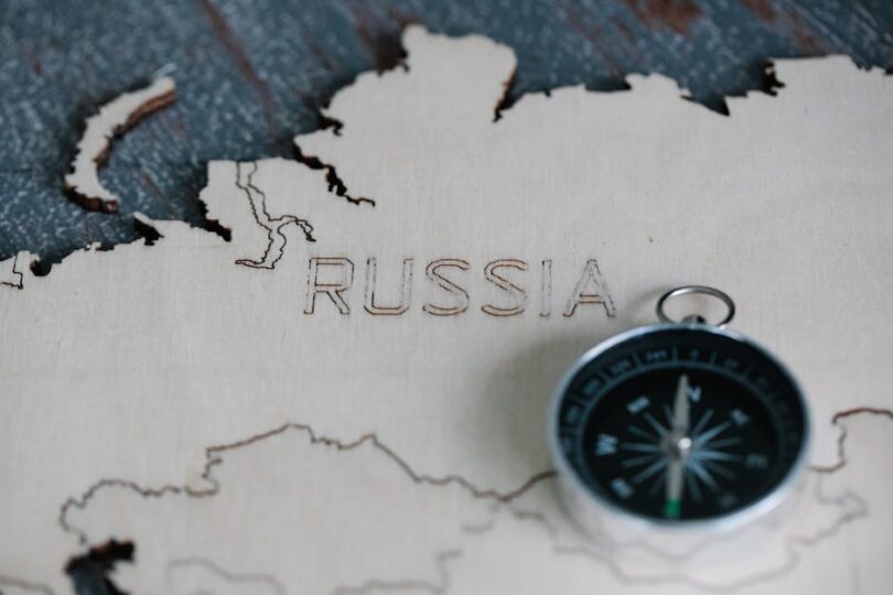 Wooden map of Russia with a compass, highlighting travel and navigation.