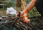 A close-up of a campfire with burning sticks. Perfect for outdoor camping themes.